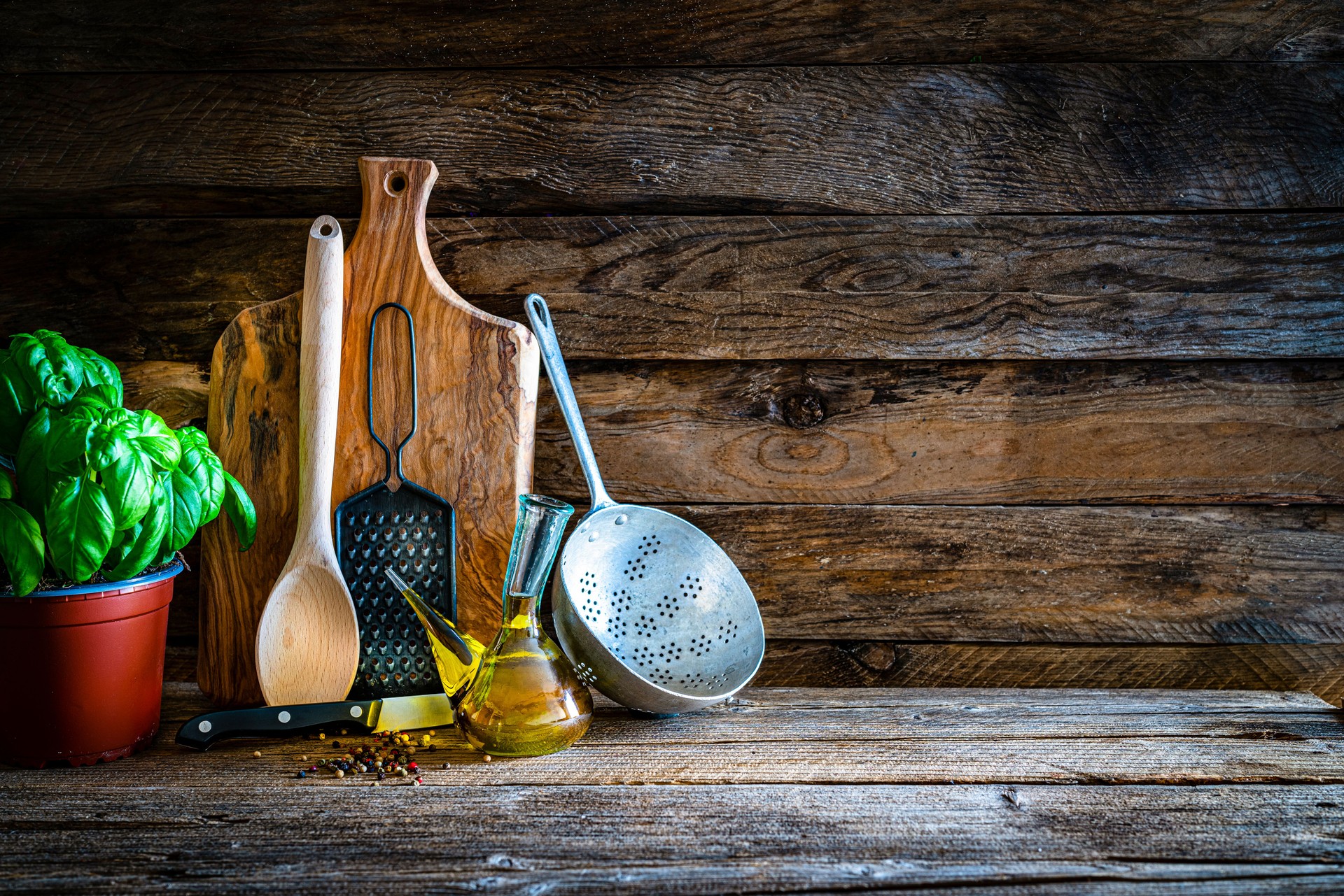 Cooking backgrounds: cutting board and kitchen utensils on wooden table. Copy space